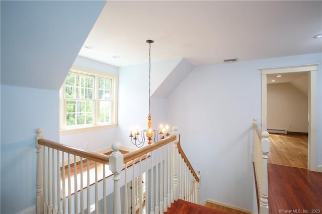 277 Ashley Falls Rd, North Canaan, CT 06018 - staircase featuring dark wood-type flooring, vaulted ceiling, a baseboard heating unit, and a chandelier