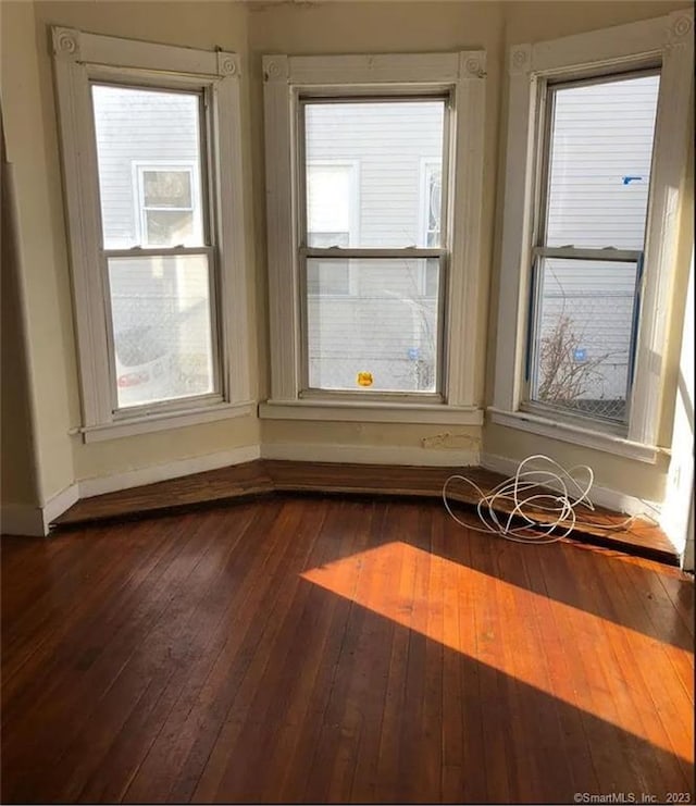 empty room with dark wood-type flooring