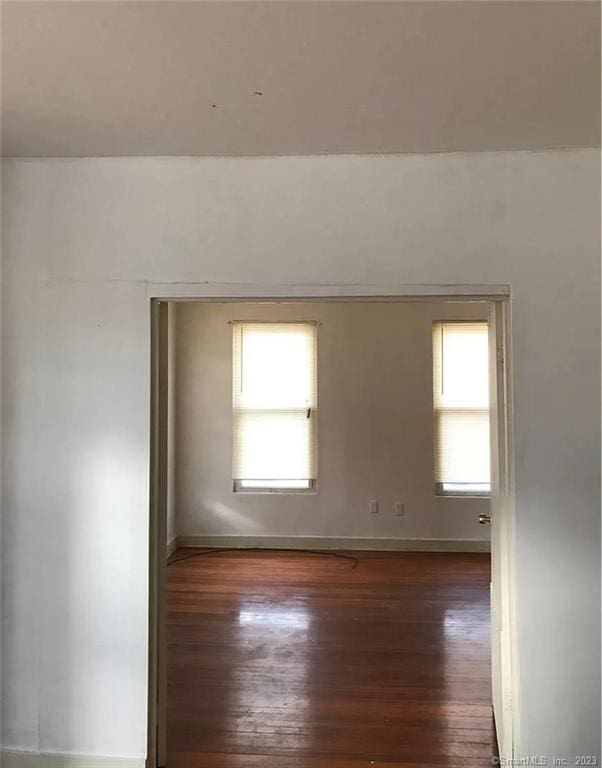 spare room with dark hardwood / wood-style flooring