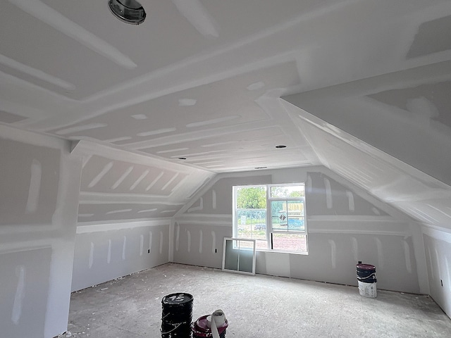 additional living space featuring vaulted ceiling