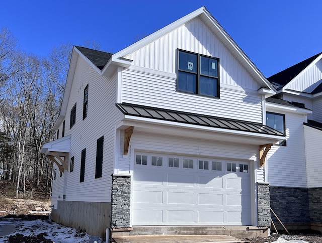 view of snow covered exterior with a garage