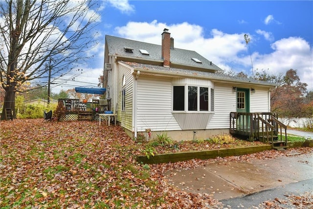 view of side of home with a deck