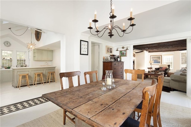 tiled dining room with a high ceiling and an inviting chandelier