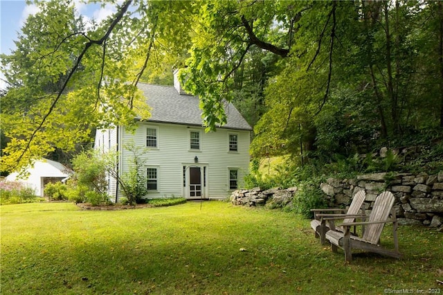 rear view of house with a lawn