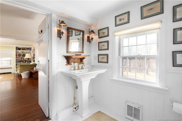 bathroom featuring a healthy amount of sunlight and hardwood / wood-style floors