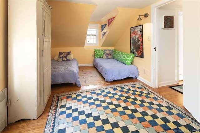 bedroom featuring light hardwood / wood-style floors and radiator