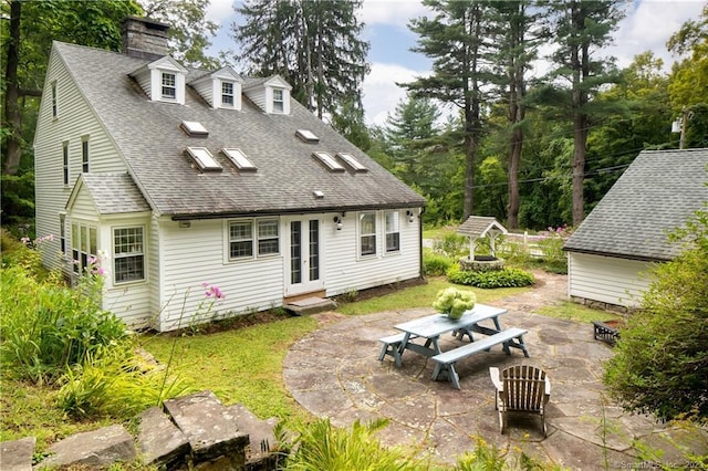 back of property with a patio area and french doors