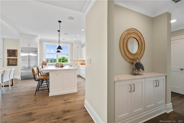 interior space with crown molding and light hardwood / wood-style flooring