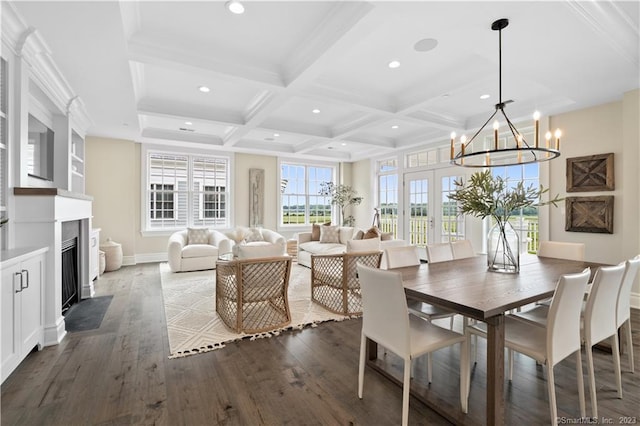 dining space featuring an inviting chandelier, coffered ceiling, dark wood-type flooring, and beamed ceiling