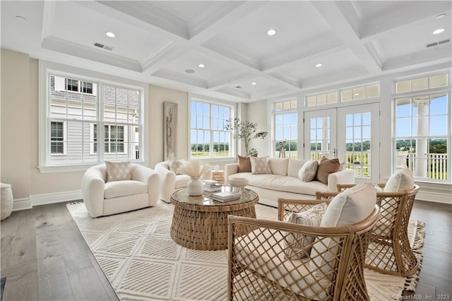 sunroom / solarium featuring plenty of natural light, beam ceiling, coffered ceiling, and french doors