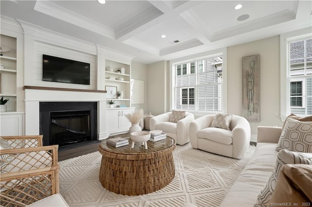 living room featuring coffered ceiling, crown molding, a wealth of natural light, and light hardwood / wood-style floors