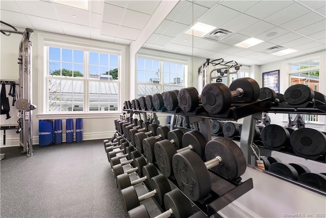 exercise room featuring plenty of natural light and a drop ceiling