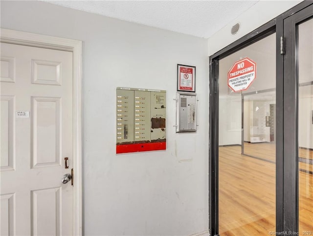 corridor with light hardwood / wood-style floors