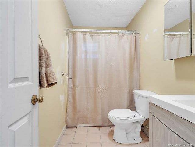 bathroom featuring tile flooring, toilet, and vanity