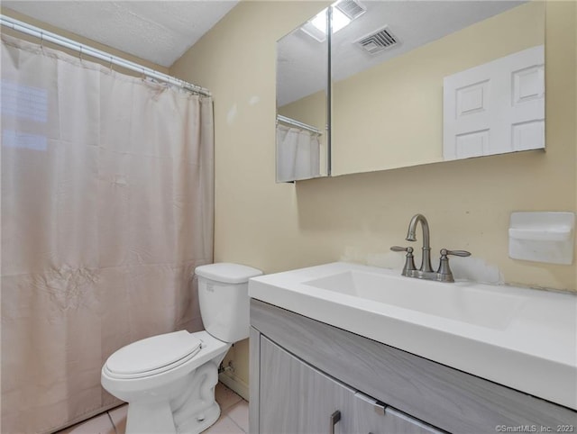 bathroom featuring tile floors, toilet, and vanity