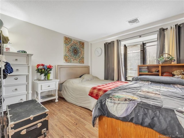 bedroom with light hardwood / wood-style flooring