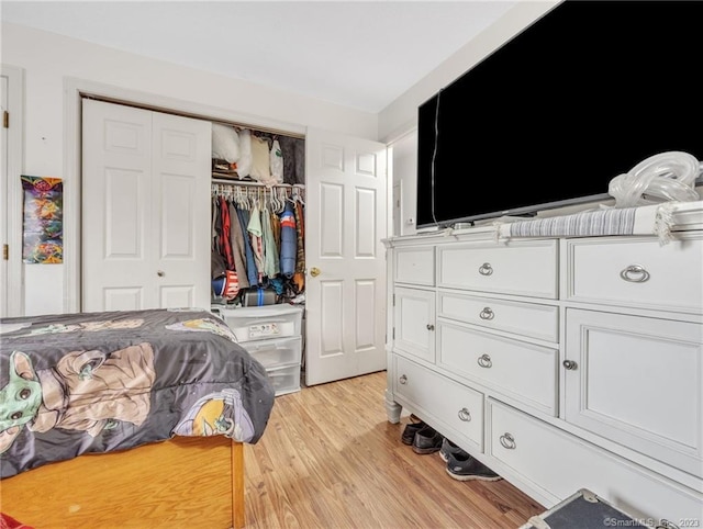 bedroom featuring a closet and light wood-type flooring