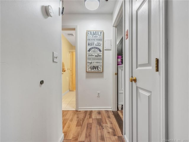 hall with light hardwood / wood-style flooring