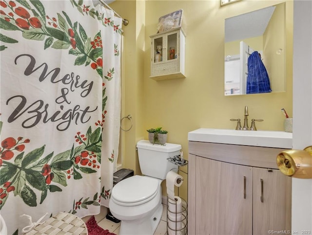 bathroom with toilet, tile flooring, and vanity