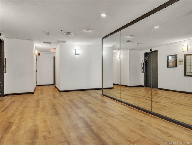 interior space with elevator and light wood-type flooring