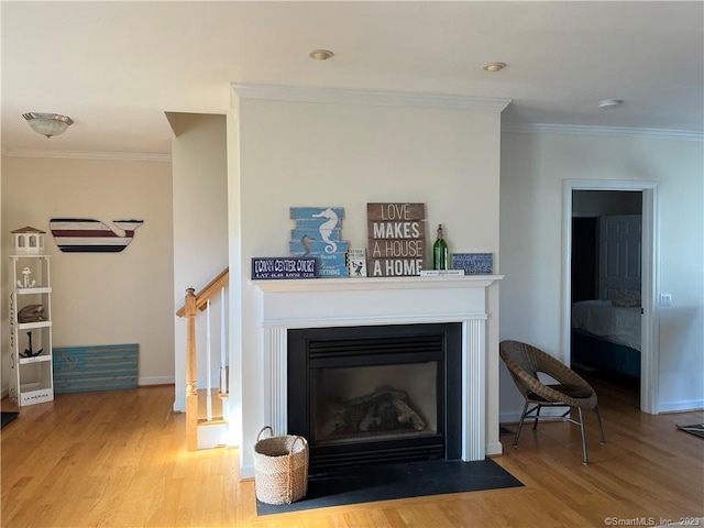 living room featuring crown molding and light wood-type flooring