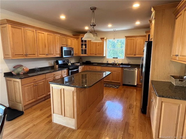 kitchen featuring dark stone counters, a center island, stainless steel appliances, light hardwood / wood-style floors, and decorative light fixtures