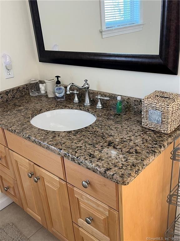 bathroom featuring tile floors and vanity