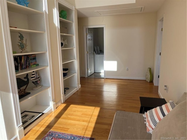 interior space with separate washer and dryer, built in features, and light hardwood / wood-style flooring