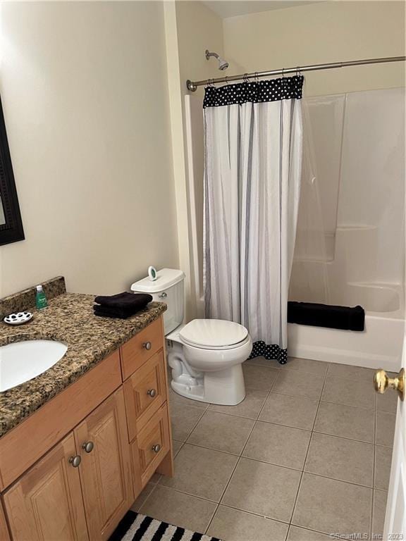 full bathroom featuring toilet, shower / bath combo, tile floors, and vanity