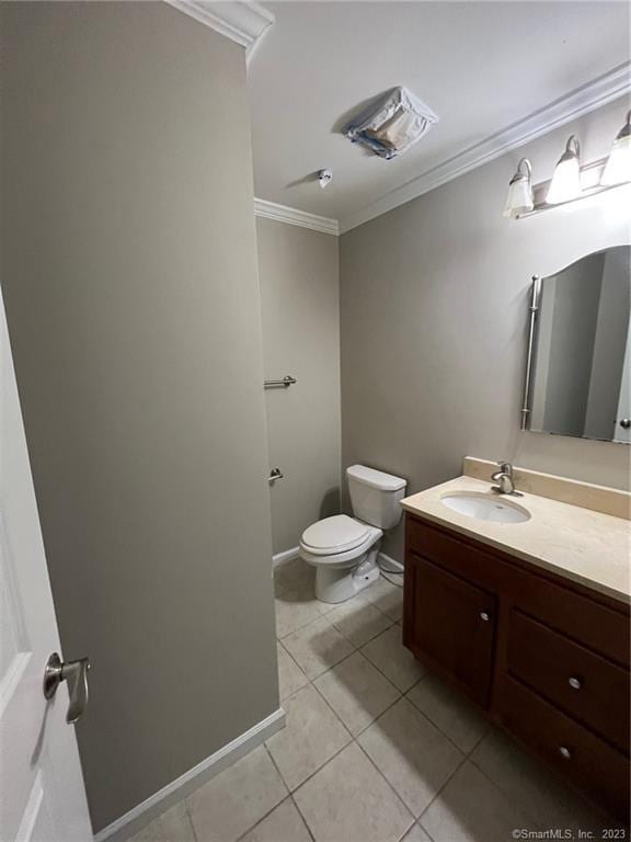 bathroom featuring crown molding, toilet, tile floors, and vanity