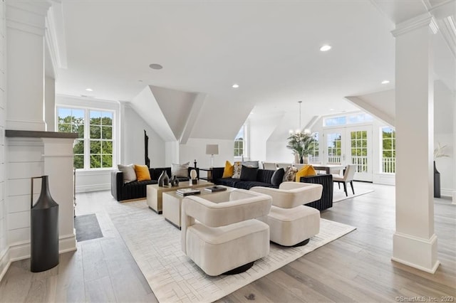 66 High St Unit 55, Guilford, CT 06437 - living area with light wood finished floors, lofted ceiling, french doors, decorative columns, and crown molding