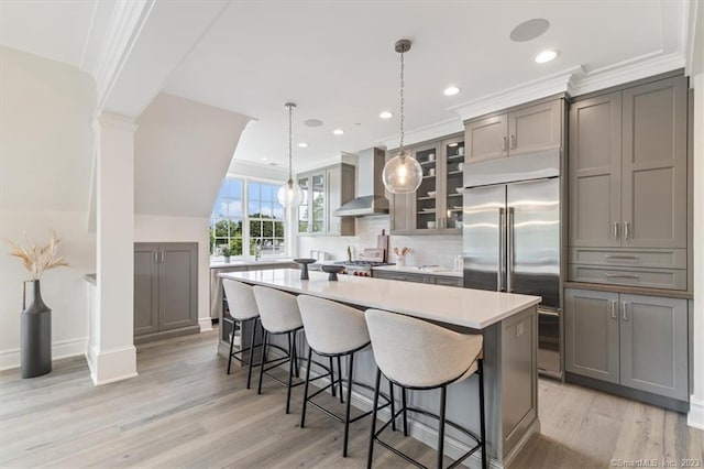 66 High St Unit 55, Guilford, CT 06437 - kitchen with wall chimney exhaust hood, built in fridge, gray cabinetry, a center island, and recessed lighting