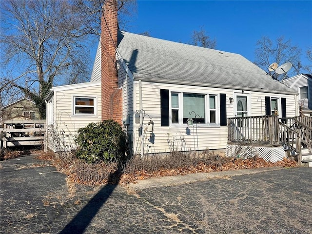 new england style home featuring a deck