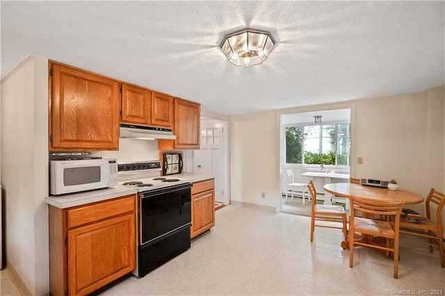 kitchen featuring range with electric cooktop, white microwave, brown cabinets, light countertops, and under cabinet range hood