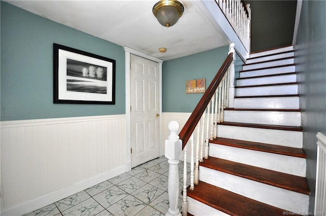 stairs featuring light tile patterned flooring