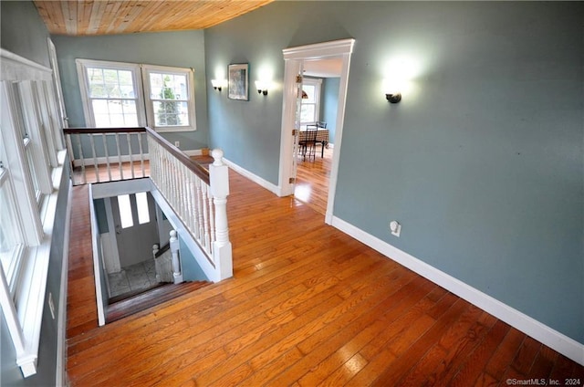 hallway featuring wooden ceiling, lofted ceiling, and hardwood / wood-style floors