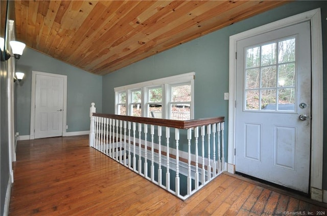 interior space with dark hardwood / wood-style flooring, wooden ceiling, and vaulted ceiling