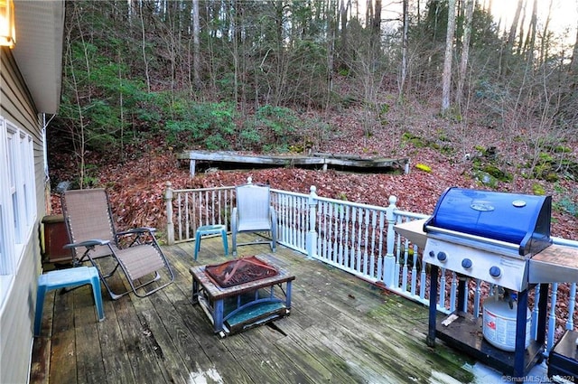 deck featuring area for grilling and an outdoor fire pit