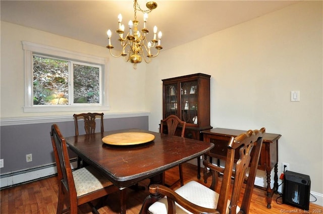 dining space featuring hardwood / wood-style flooring, a notable chandelier, and baseboard heating