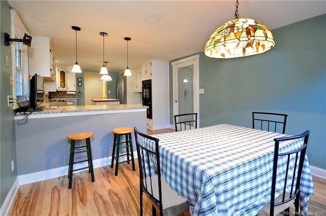 dining area featuring light wood-type flooring