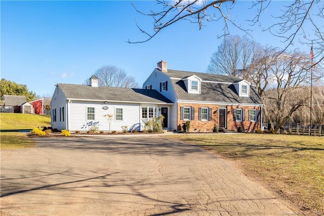 630 Cook Hill Rd, Cheshire, CT 06410 - dutch colonial with driveway, a front lawn, a chimney, and brick siding