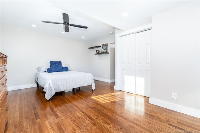 bedroom with ceiling fan, hardwood / wood-style floors, and a closet