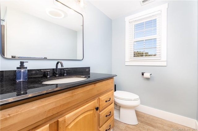 bathroom featuring hardwood / wood-style flooring, vanity, and toilet