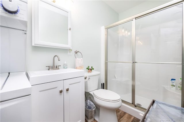 bathroom with toilet, an enclosed shower, vanity, and hardwood / wood-style floors