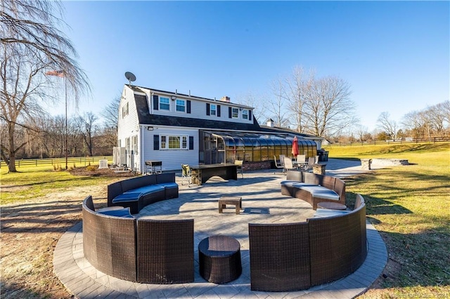 rear view of property with a patio, a yard, and an outdoor living space