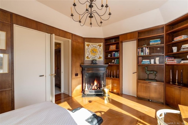 bedroom featuring an inviting chandelier and light wood-type flooring