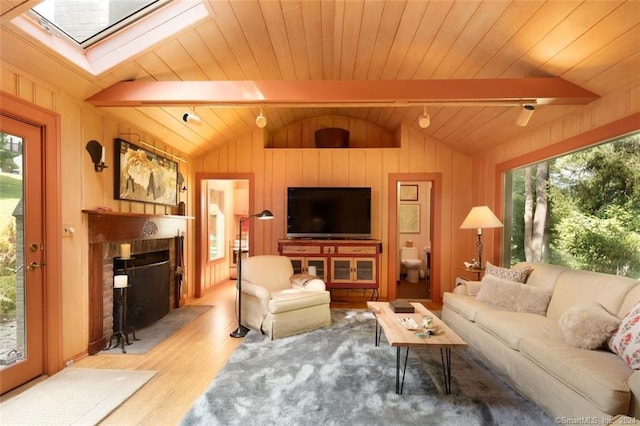 living room with wooden walls, light wood-type flooring, wooden ceiling, and lofted ceiling with skylight