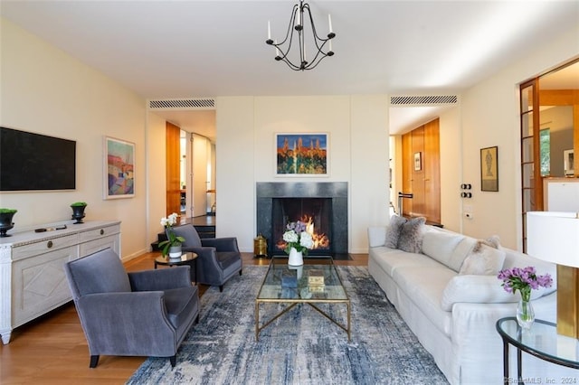 living room with dark hardwood / wood-style floors and a notable chandelier