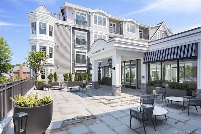 rear view of house featuring a balcony and a patio area