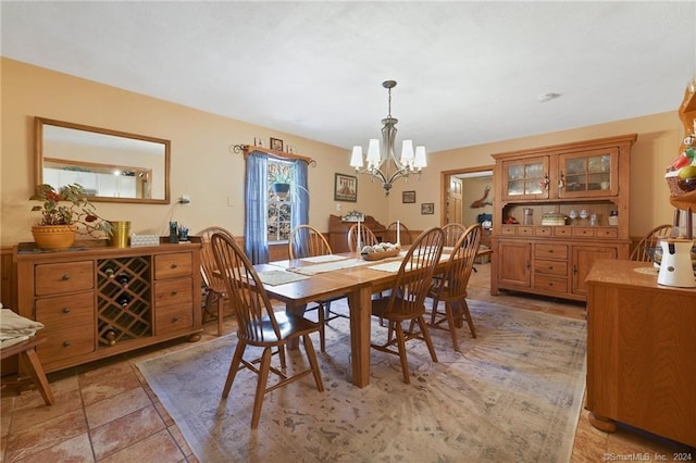 tiled dining area featuring a chandelier